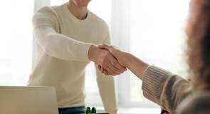 cinclus pharma man standing up and woman sitting down shaking hands