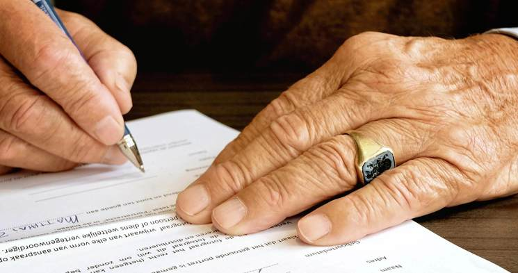cinclus pharma close-up on elderly mans hands signing a contract